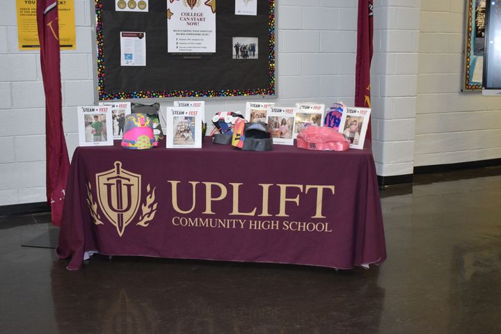 Table with a Uplift Community High School banner